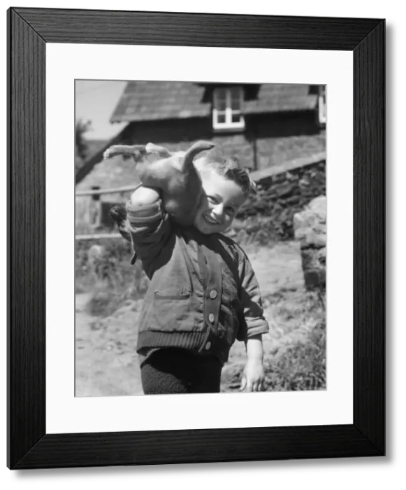Framed Print : Young boy playing with a puppy Framed Print : Young boy playing with a puppy