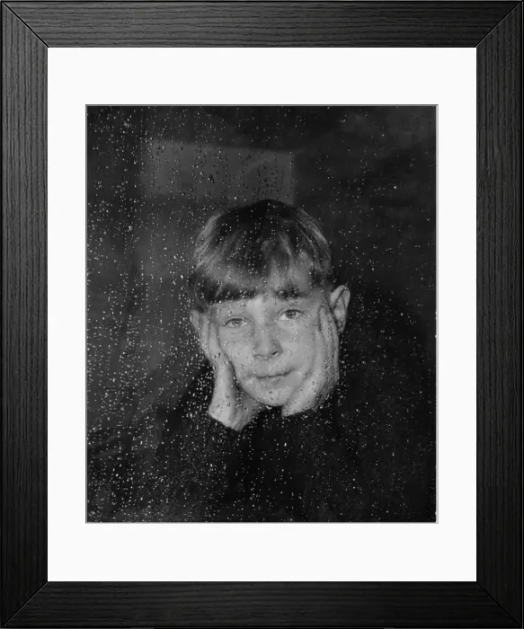 Framed Print : Boy looking through a window on a rainy day Framed Print : Boy looking through a window on a rainy day