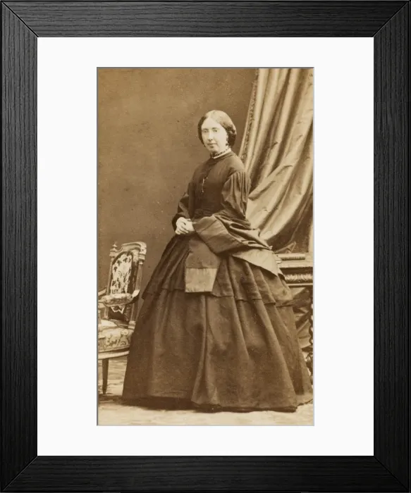 Framed Print : Middle-aged Victorian woman in a dark crinoline dress Framed Print : Middle-aged Victorian woman in a dark crinoline dress