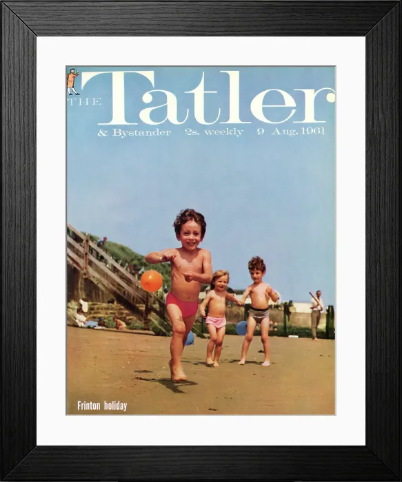 Framed Print : Tatler Front Cover - Three small children, two boys and a girl, are playing on the beach at Frinton-on-Sea, holding blue and orange balloons on strings Framed Print : Tatler Front Cover - Three small children, two boys and a girl, are playing on the beach at Frinton-on-Sea, holding blue and orange balloons on strings