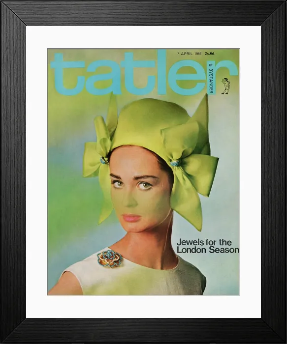 Framed Print : Tatler Front Cover - A woman looking at the camera wearing a green hat with bows on each side, pink lipstick, and a blue diamond brooch Framed Print : Tatler Front Cover - A woman looking at the camera wearing a green hat with bows on each side, pink lipstick, and a blue diamond brooch