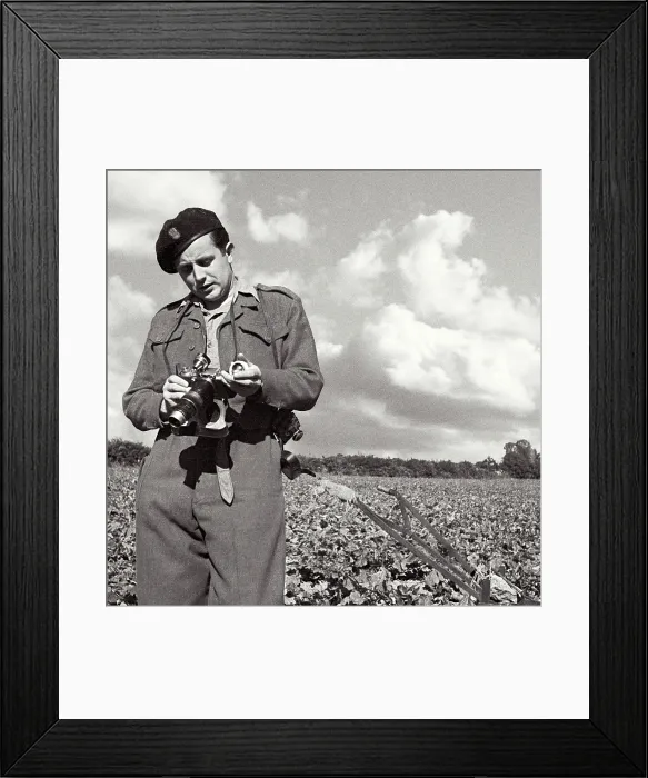 Framed Print : John standing in field in uniform carefully adjusting his camera. Yorkshire, Pickering area. One of a set of several-probably summer. Date: 1947 - 1948 Framed Print : John standing in field in uniform carefully adjusting his camera. Yorkshire, Pickering area. One of a set of several-probably summer. Date: 1947 - 1948