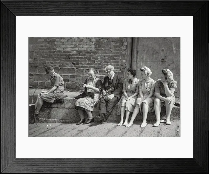 Framed Print : Villagers sitting casually and chatting, no shoes, knitting, old man with camera in group Date: 1947 - 1948 Framed Print : Villagers sitting casually and chatting, no shoes, knitting, old man with camera in group Date: 1947 - 1948