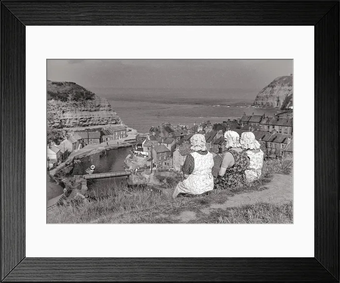 Framed Print : Three women in bonnets and pinifores looking down on Staithes harbour Date: 1947 - 1948 Framed Print : Three women in bonnets and pinifores looking down on Staithes harbour Date: 1947 - 1948