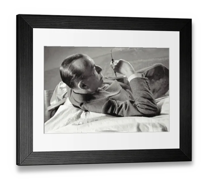 Framed Print : Noel Coward sits with cigarette in holder during rehearsal of Relative Values which opened at The Savoy Theatre in November 1951 Date: 1951 Framed Print : Noel Coward sits with cigarette in holder during rehearsal of Relative Values which opened at The Savoy Theatre in November 1951 Date: 1951