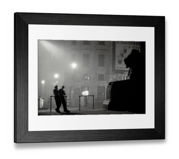 Framed Print : Atmospheric shot of two policement in silhouette resting in Trafalgar Square in front of giant lion statue Date: early 1950s Framed Print : Atmospheric shot of two policement in silhouette resting in Trafalgar Square in front of giant lion statue Date: early 1950s