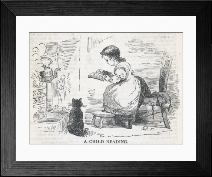 Framed Print : Child Reads by Stove Framed Print : Child Reads by Stove