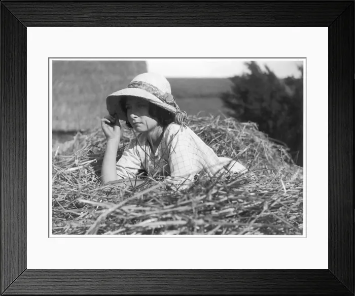 Framed Print : Girl Lying on Haystack Framed Print : Girl Lying on Haystack