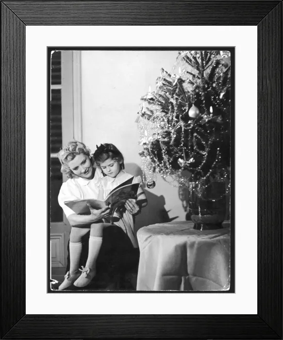 Framed Print : Reading under C mas Tree Framed Print : Reading under C mas Tree