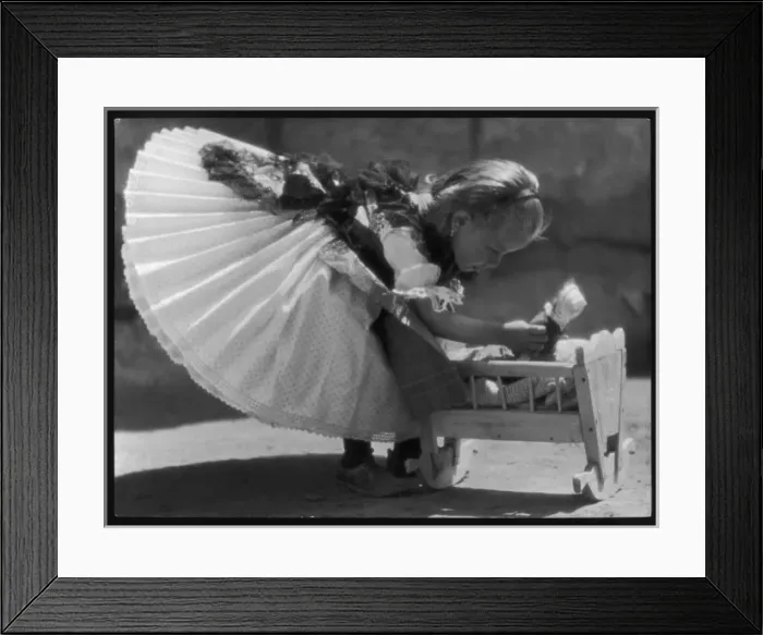 Framed Print : Girl and Doll in Crib Framed Print : Girl and Doll in Crib
