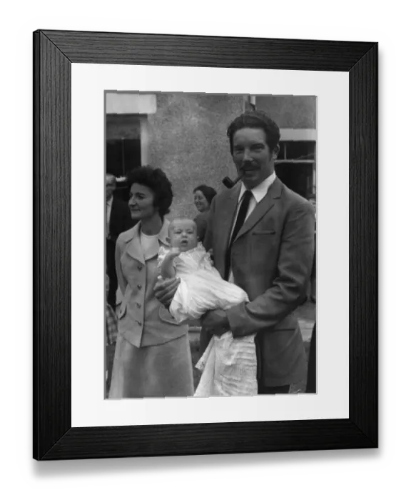 Framed Print : Godfather holding baby at a christening Framed Print : Godfather holding baby at a christening