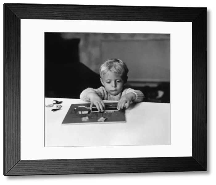 Framed Print : Boy Playing with Puzzle Framed Print : Boy Playing with Puzzle