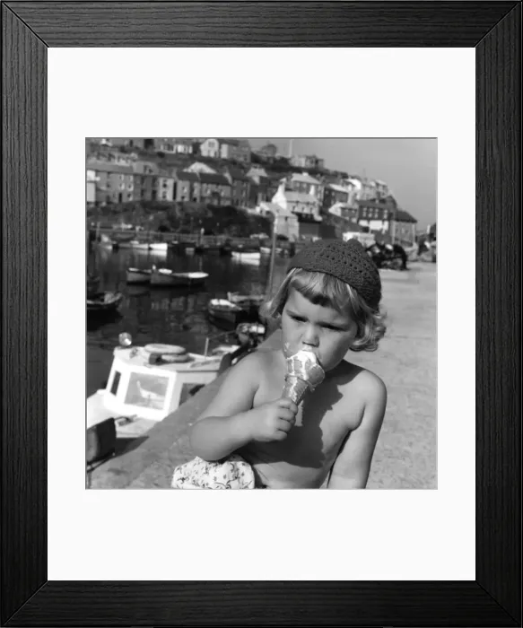 Framed Print : Little girl eating an ice cream, Cornwall Framed Print : Little girl eating an ice cream, Cornwall