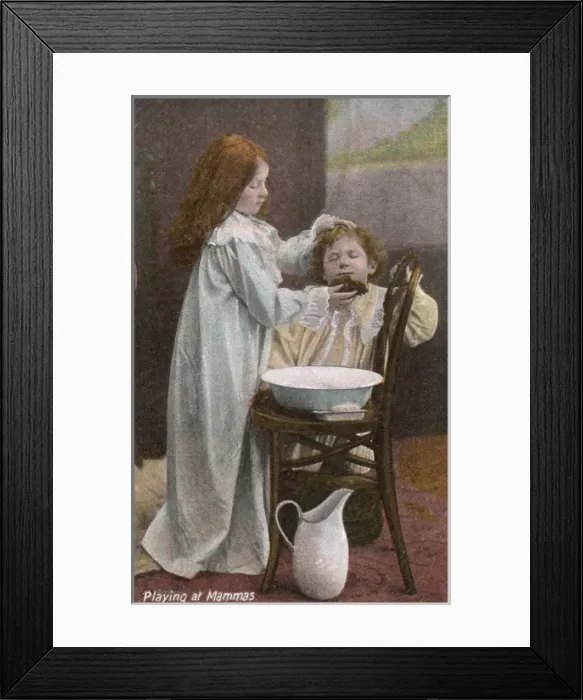 Framed Print : Playing at Mammas -- girl washes boys face Framed Print : Playing at Mammas -- girl washes boys face