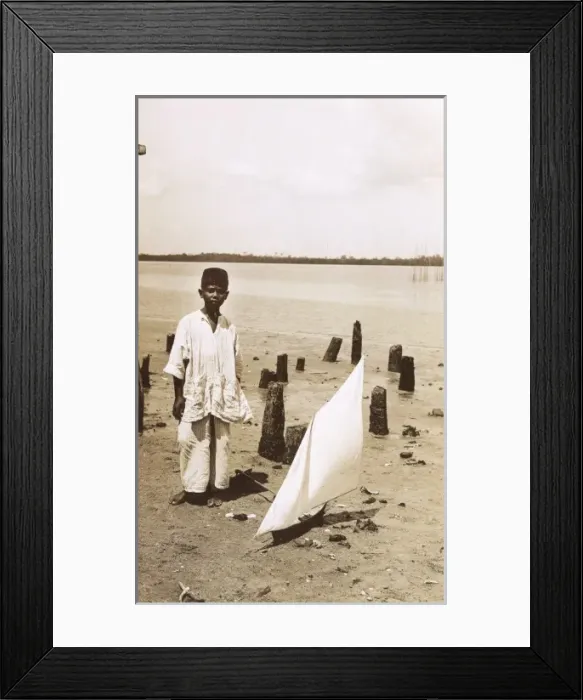 Framed Print : A Malaysian boy with a toy yacht Framed Print : A Malaysian boy with a toy yacht