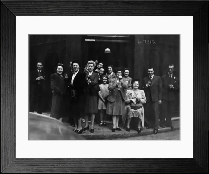 Framed Print : Cheers. A group of people raise their glasses of beer in a toast outside Framed Print : Cheers. A group of people raise their glasses of beer in a toast outside