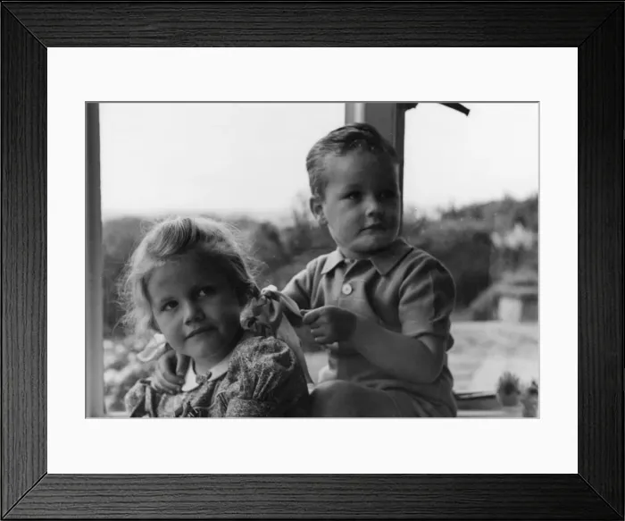 Framed Print : Boy and girl sitting in a window Framed Print : Boy and girl sitting in a window