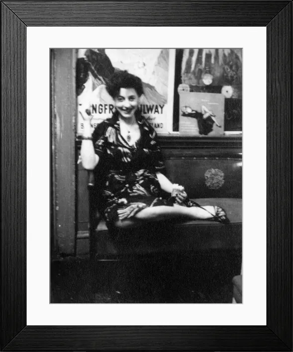 Framed Print : Young woman sitting on a bench Framed Print : Young woman sitting on a bench