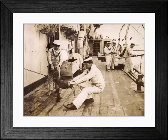 Framed Print : Sailor binding a swab, sitting on a rope, WW1 Framed Print : Sailor binding a swab, sitting on a rope, WW1