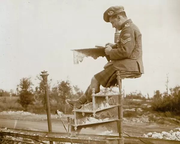 Scottish soldier writing home on a spiral staircase, WW1