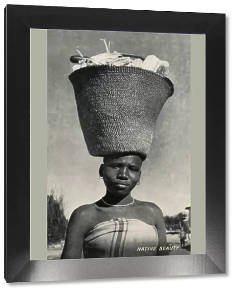 Africa woman carrying maize on her head