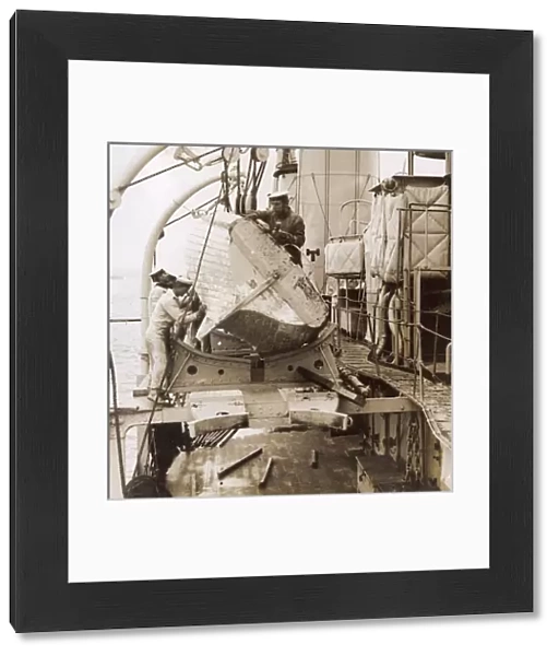 Sailors repairing a boat on a ship, WW1