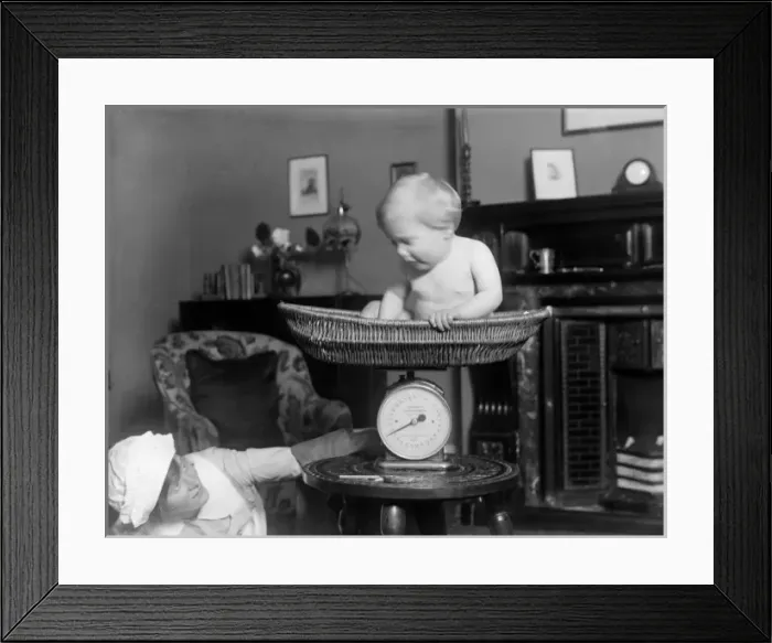Framed Print : Weighing Baby Framed Print : Weighing Baby