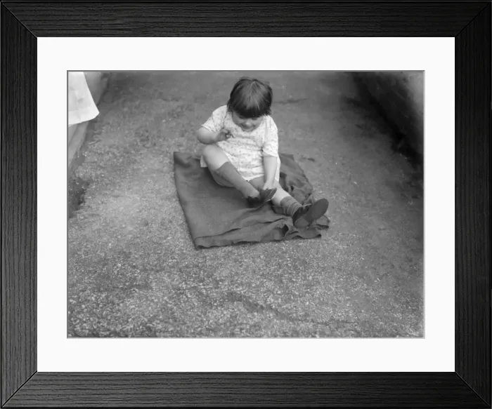 Framed Print : Putting Shoes On Framed Print : Putting Shoes On
