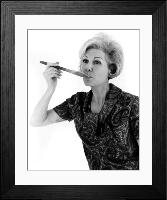 Framed Print : YUMMY. A woman sees what her cooking tastes like. Date: late 1960s Framed Print : YUMMY. A woman sees what her cooking tastes like. Date: late 1960s