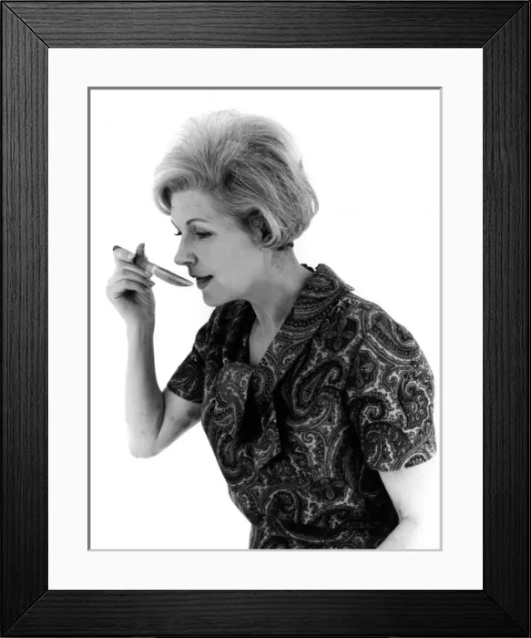 Framed Print : YUMMY. A woman sees what her cooking tastes like. Date: late 1960s Framed Print : YUMMY. A woman sees what her cooking tastes like. Date: late 1960s