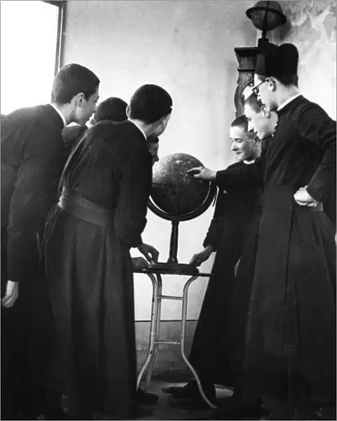 Priests Studying Globe