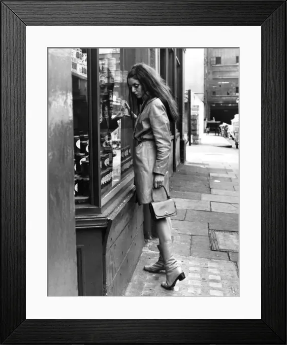 Framed Print : SHOPPING. A woman looks at a can of food through a shop window. Date: late 1960s Framed Print : SHOPPING. A woman looks at a can of food through a shop window. Date: late 1960s