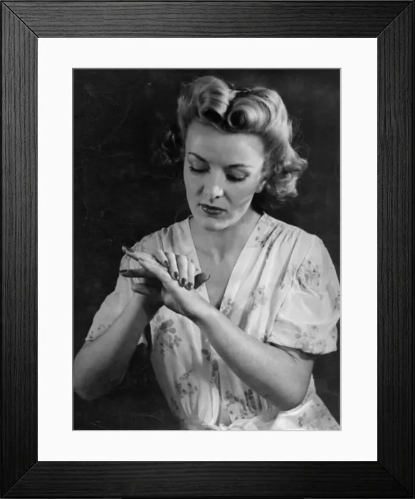 Framed Print : HAND CARE. A stylish model rubs lotion into her lovely hands to keep them soft and supple Framed Print : HAND CARE. A stylish model rubs lotion into her lovely hands to keep them soft and supple