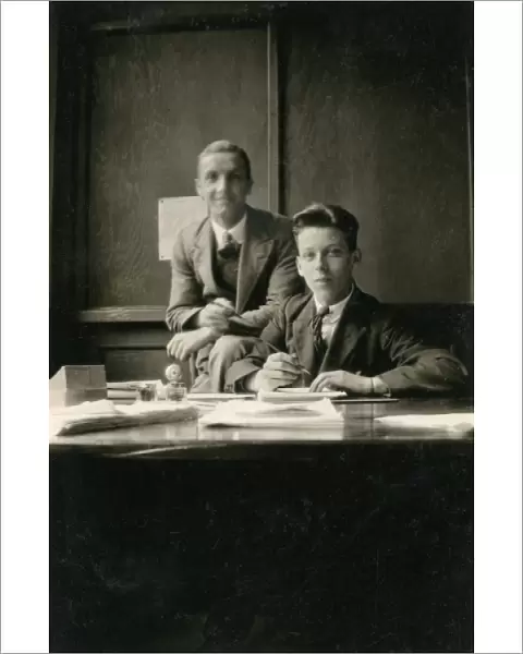 Two young clerks in an office