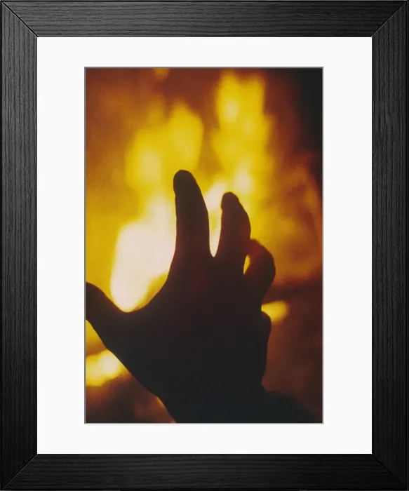 Framed Print : FIRE. A hand hovering over a burning flame! Date: 1971 Framed Print : FIRE. A hand hovering over a burning flame! Date: 1971