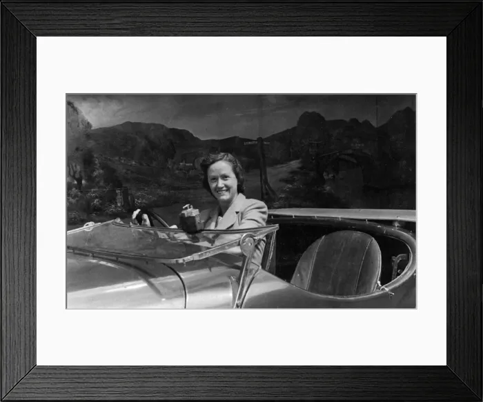 Framed Print : Young woman at wheel of car in studio photo Framed Print : Young woman at wheel of car in studio photo