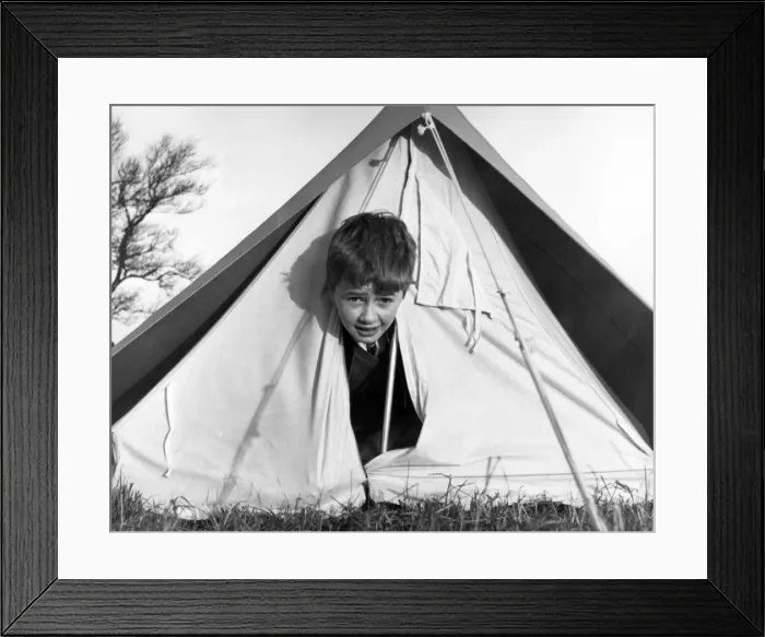 Framed Print : TENT BOY. A little boy peeping out of a tent! Date: 1960s Framed Print : TENT BOY. A little boy peeping out of a tent! Date: 1960s
