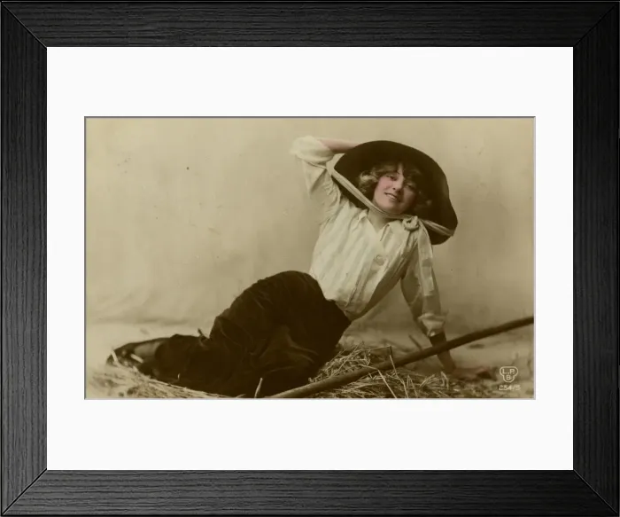 Framed Print : Young woman in a large hat sitting on straw Framed Print : Young woman in a large hat sitting on straw
