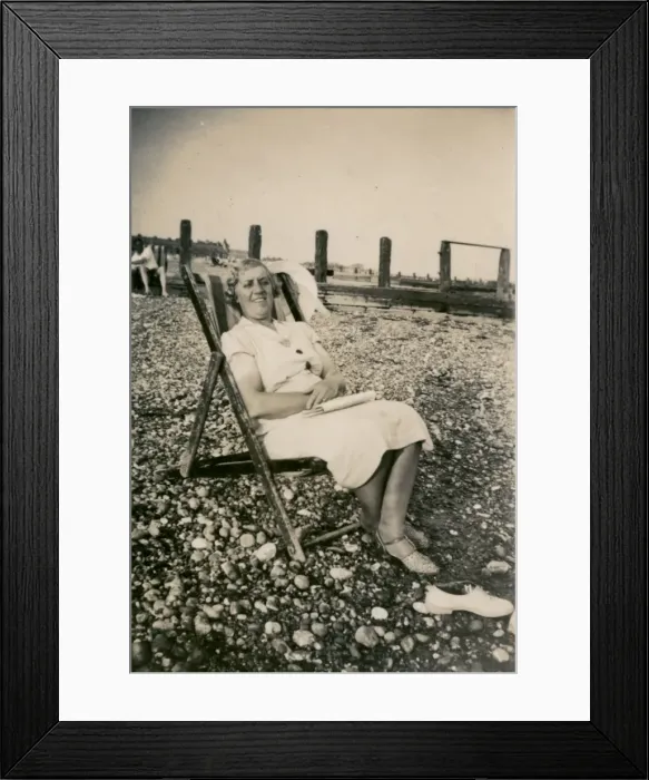 Framed Print : Woman on holiday, sitting in a deckchair Framed Print : Woman on holiday, sitting in a deckchair
