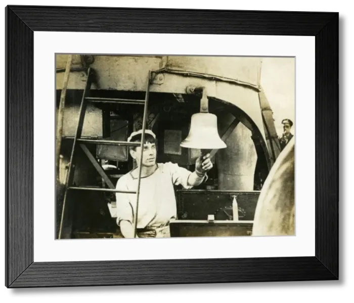 Framed Print : Sailor ringing new bell of HMS Broke, WW1 Framed Print : Sailor ringing new bell of HMS Broke, WW1