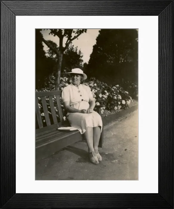 Framed Print : Woman on holiday, sitting on a bench Framed Print : Woman on holiday, sitting on a bench