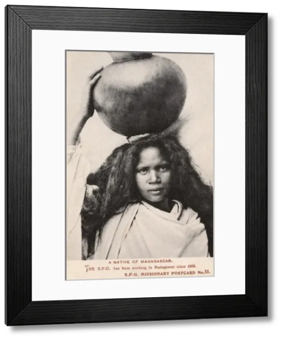 Framed Print : Madagascar - Girl carrying a large round jar Framed Print : Madagascar - Girl carrying a large round jar