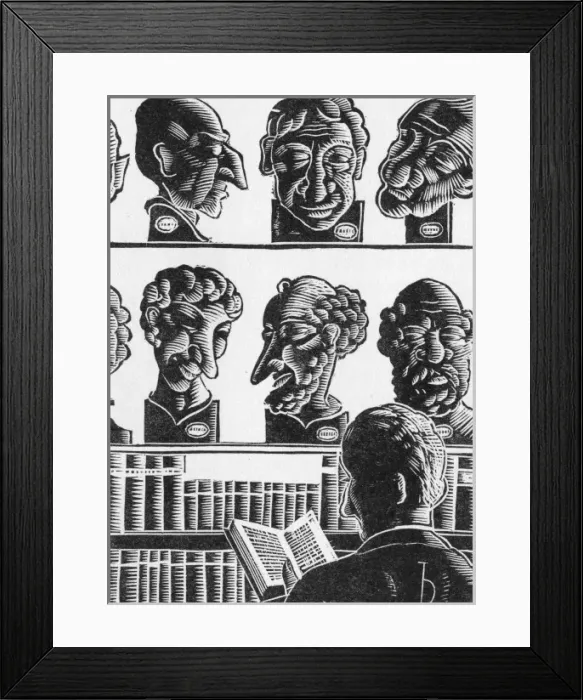 Framed Print : A man reads a book in a shop Framed Print : A man reads a book in a shop