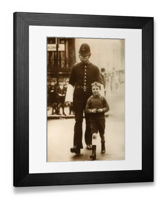 Framed Print : Policeman helping a young boy cross the road Framed Print : Policeman helping a young boy cross the road
