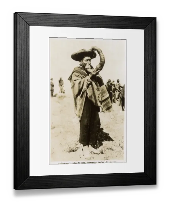 Framed Print : Indian blowing a trumpet made of horn Framed Print : Indian blowing a trumpet made of horn