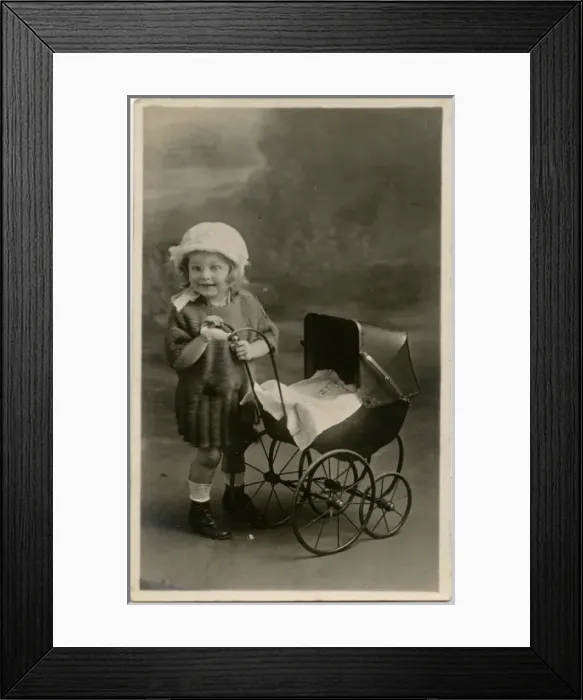 Framed Print : Little girl with toy pram Framed Print : Little girl with toy pram