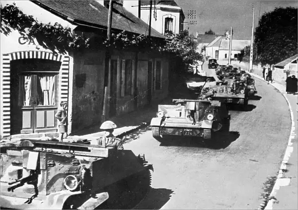 British machine gun carriers passing through French village