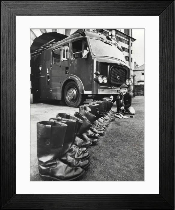 Framed Print : Cub Scout cleaning firemens boots, Surrey Framed Print : Cub Scout cleaning firemens boots, Surrey