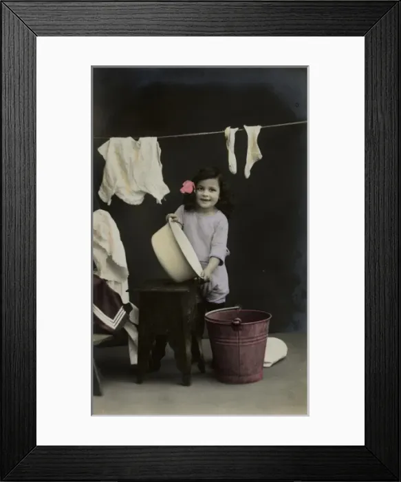 Framed Print : Little girl on a postcard, hanging up the washing Framed Print : Little girl on a postcard, hanging up the washing
