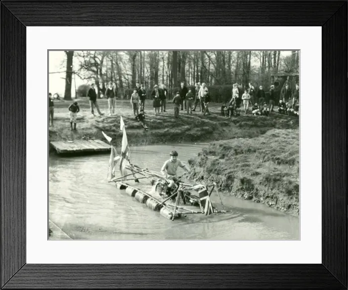Framed Print : Boy operating pedal-driven drum raft Framed Print : Boy operating pedal-driven drum raft